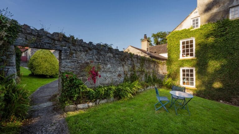 Table and chairs in secluded corner of garden